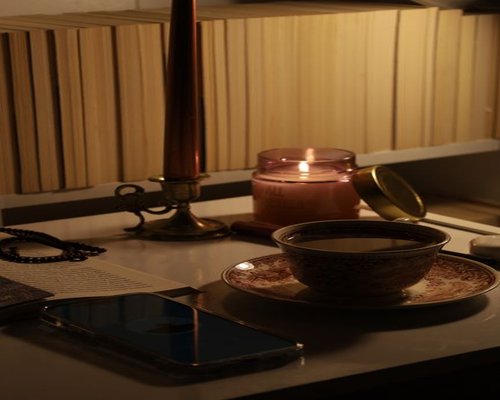 A relaxed evening setting with dimmed lights and a book